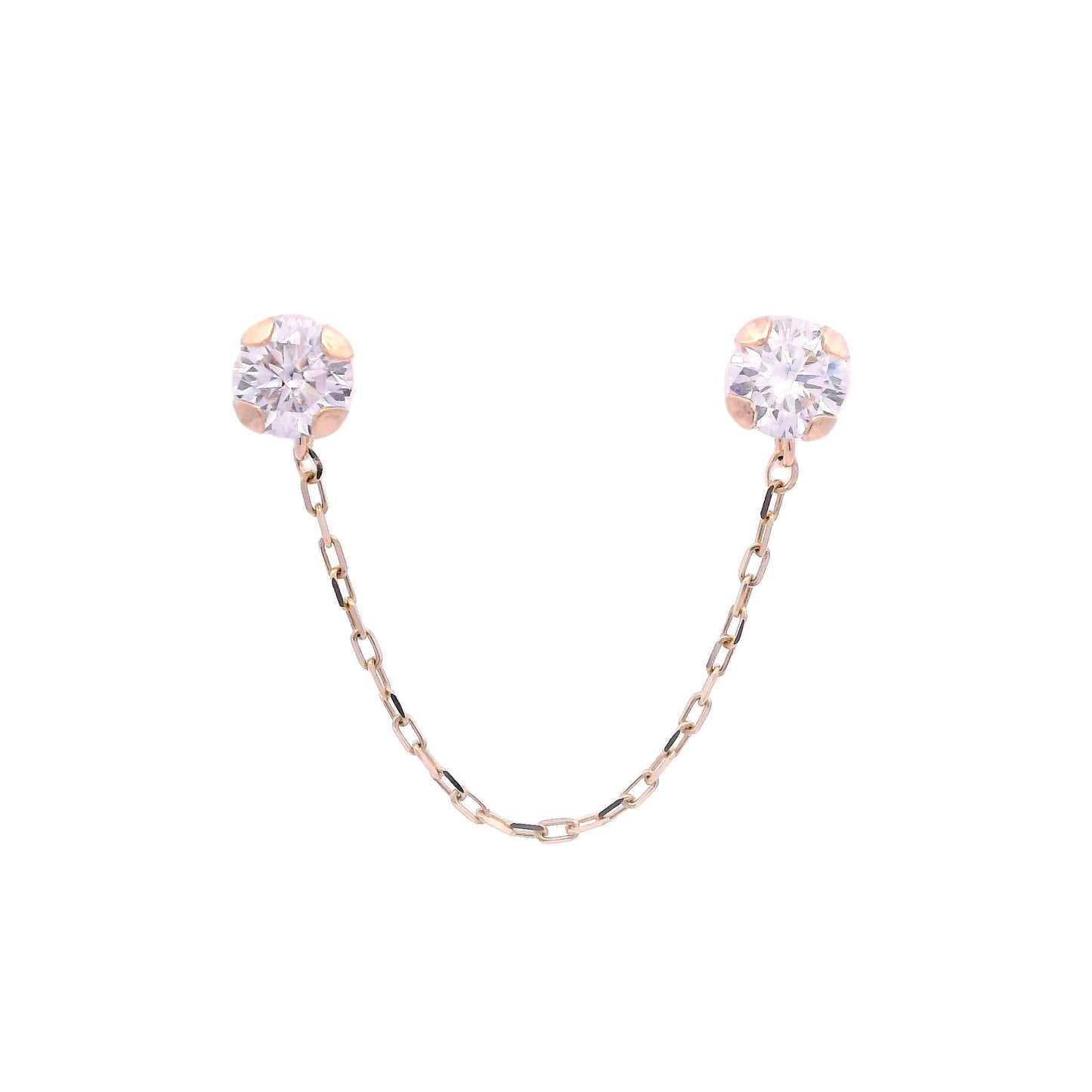 Front view of two round white zirconia studs with a 14k yellow gold base. They are connected by a thin yellow gold chain.