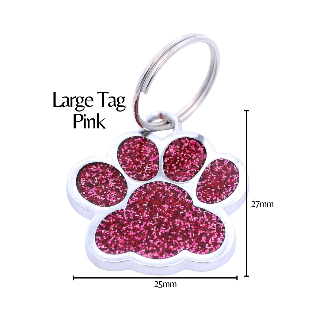 Pink glitter paw print tag with dimensions on a white background. There is black text that says "Large Tag Pink" and the height is labeled as 27mm and the width as 25mm.