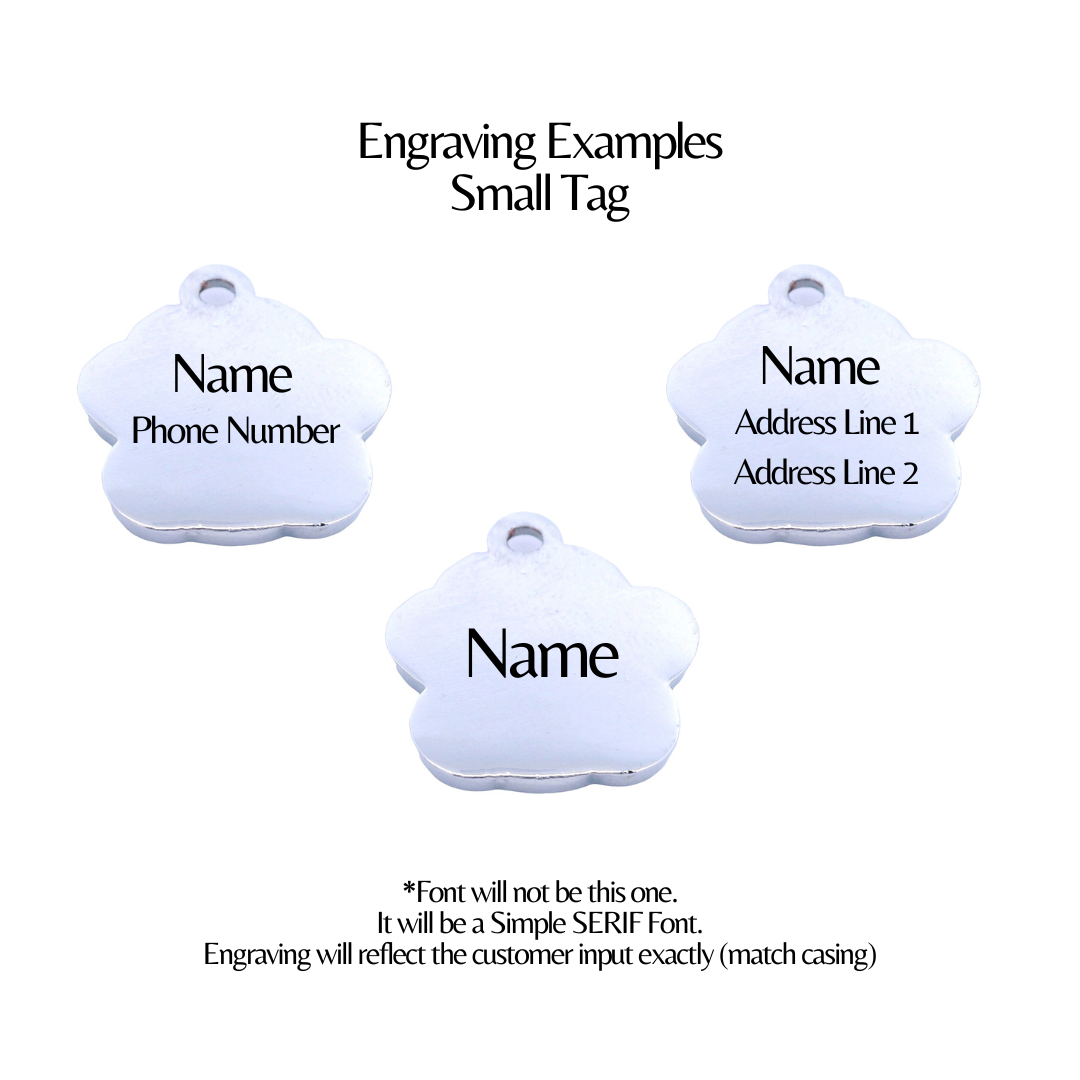 Three small white tags with engraved text examples on a white background
