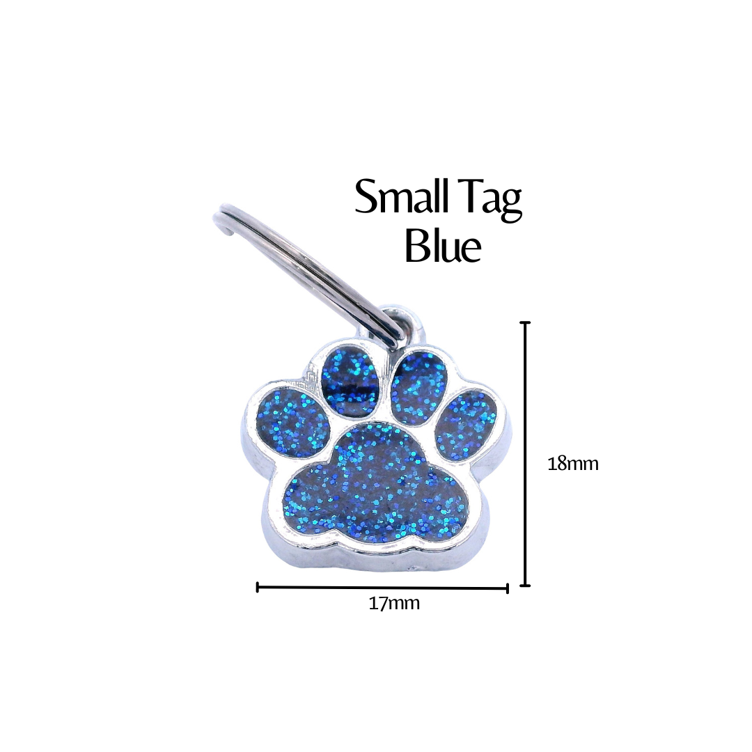 Blue glitter paw print tag with dimensions on a white background. There is black text that says "Small Tag Blue" and the height is labeled as 18mm and the width as 17mm.