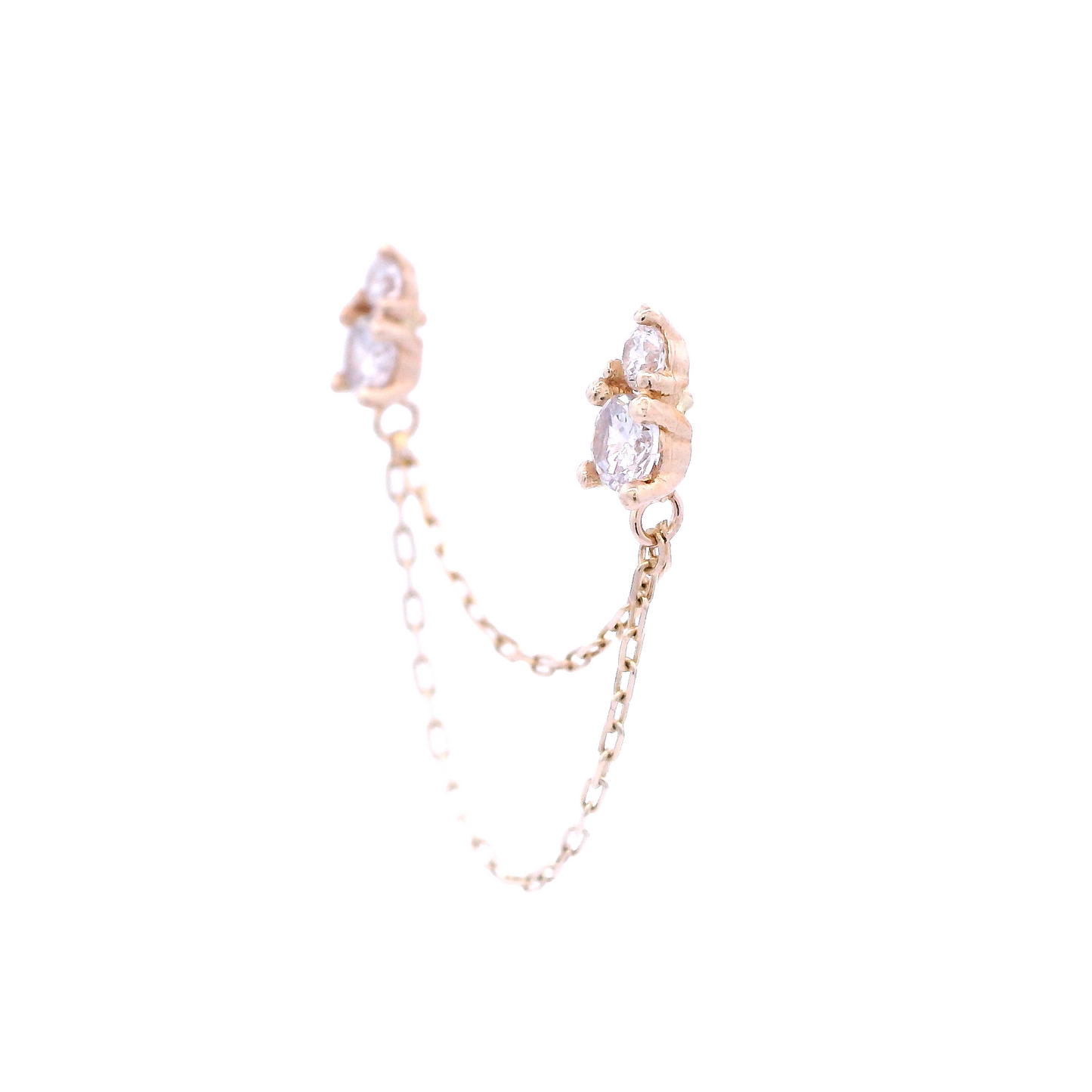 Angled view of two pear-shaped studs connected by two yellow gold chains of different lengths. The pear-shaped studs have a yellow gold base. The pear shape is created by combining two round white zirconia of different diameters.