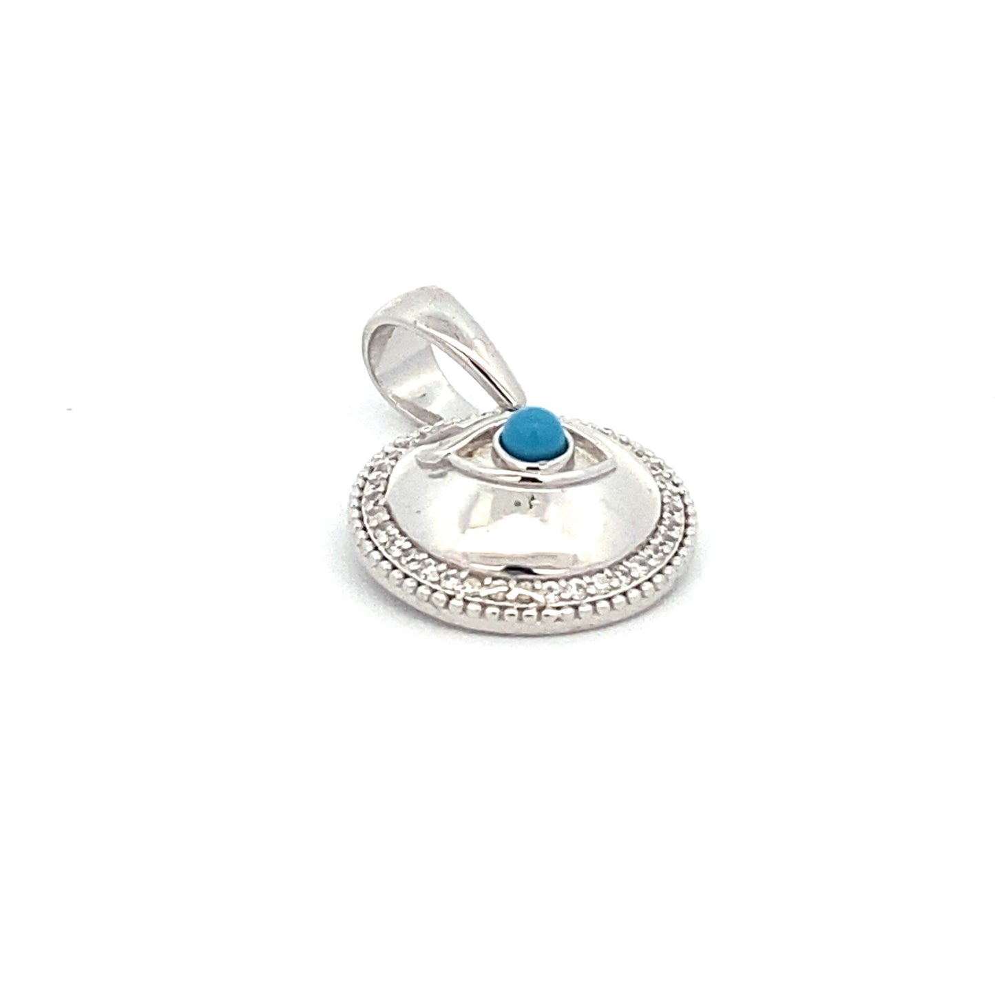 Round Evil Eye Pendant with Zirconia. close up of pendant laying down