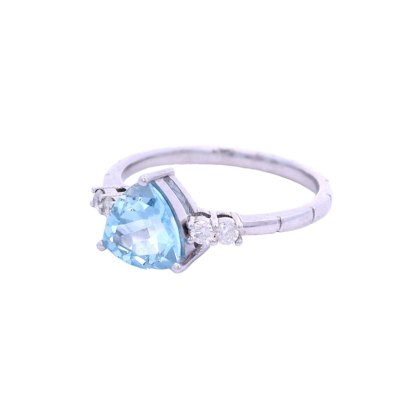 Side view of white gold ring. The ring has a triangular light blue aquamarine stone in the center. On each side of the stone there are2 small round white diamonds.