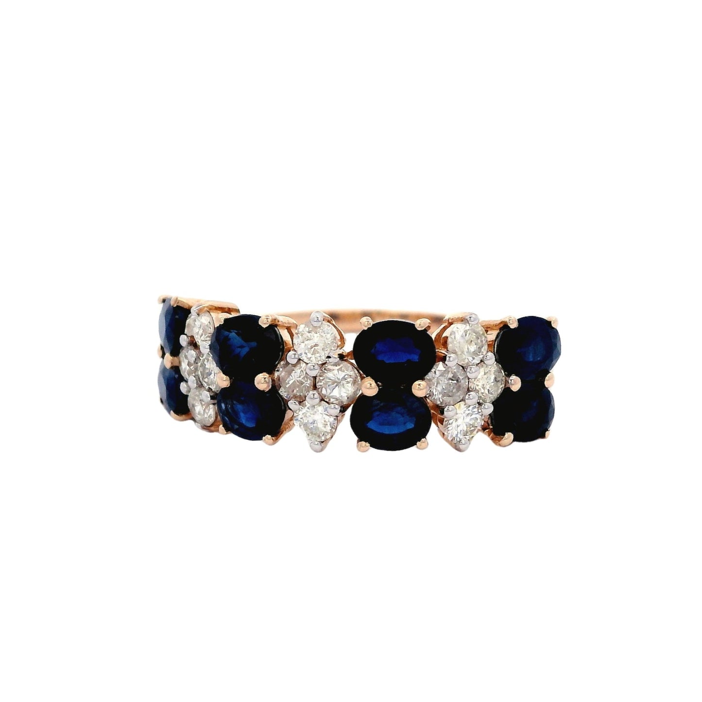 Front angled view of yellow gold ring. The ring has a pattern between blue sapphire and white diamond. The blue sapphire section has two oval blue sapphires laying horizontally. The diamond section has four round diamonds in the shape of a rhombus.