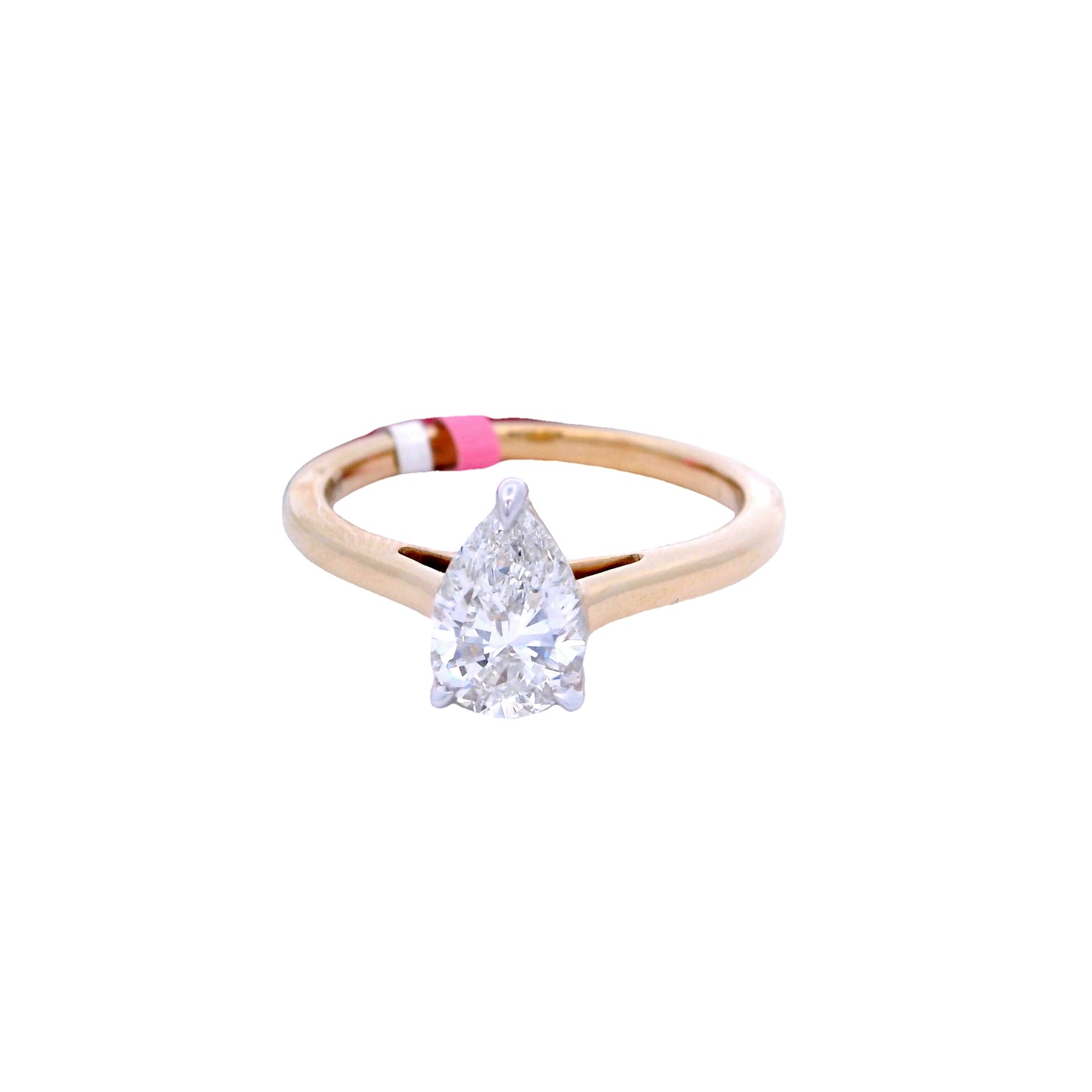 Front view of a ring with a gold band and a white pear-shaped diamond in the center.