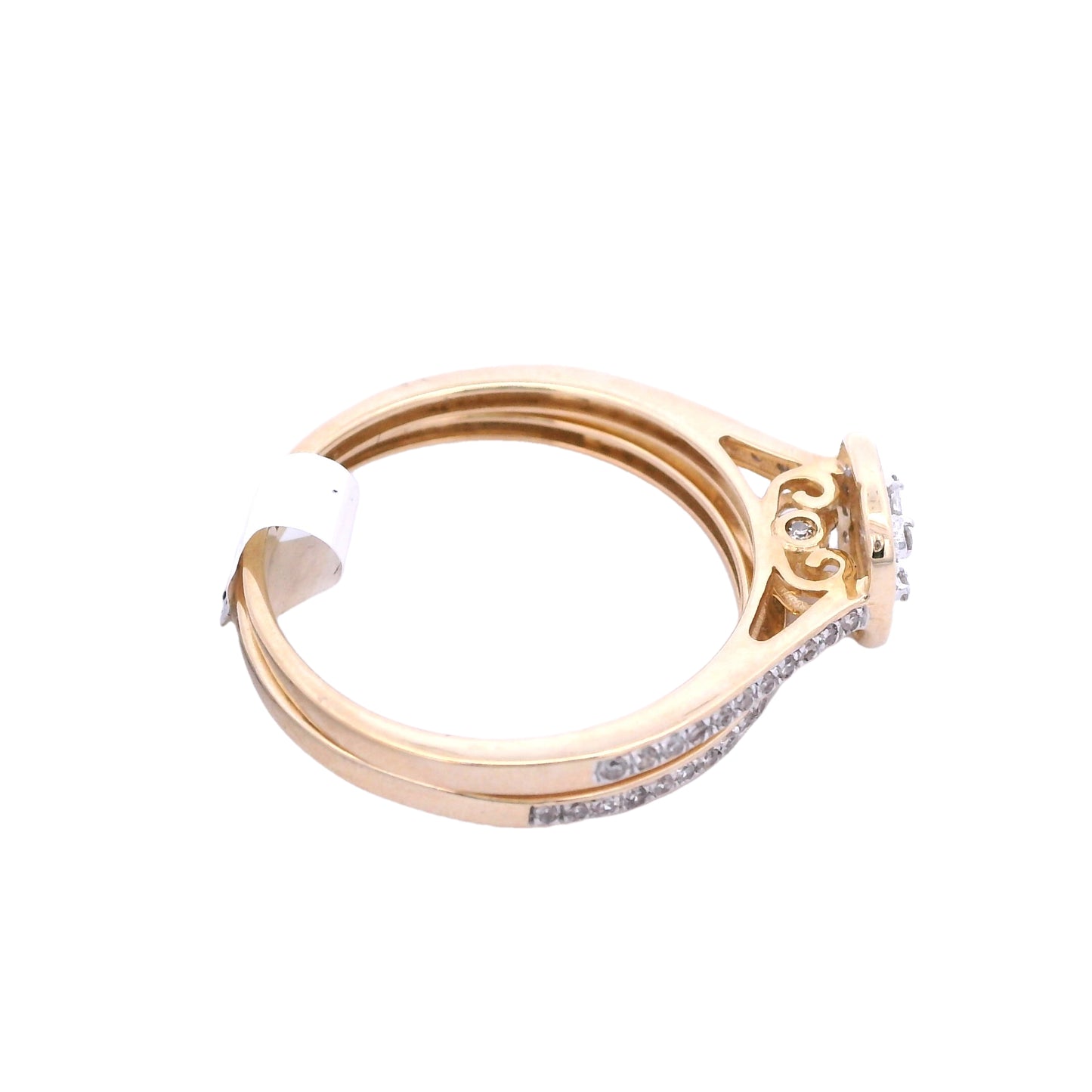 Angled aerial view of yellow gold bridal set. The engagement ring has a cushion center made up of small square diamonds. It has a halo around it made up of round diamonds, and is outlined in yellow gold. The band of the ring has round diamonds that go about halfway through each side of the band. It is on top of the wedding bands. The wedding band is under it. It is a yellow gold thin band with round white diamonds.