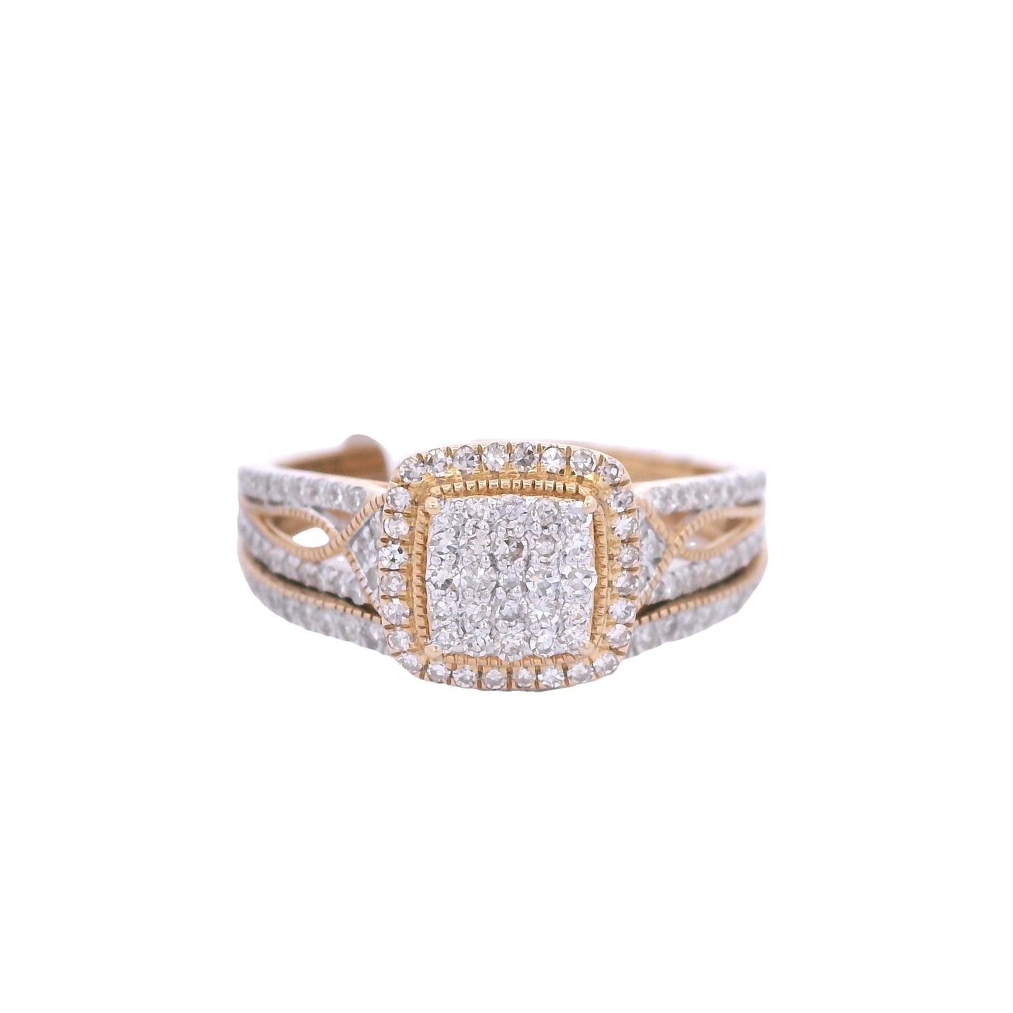 Front view of yellow gold bridal set. The engagement ring is laying on top. It has a square cushion center filled with round diamonds. Outside the center there is a thin gold out line and then a halo made up of round diamonds. The wedding band is below it and fits perfectly. It has white round diamonds throughout the front of it.