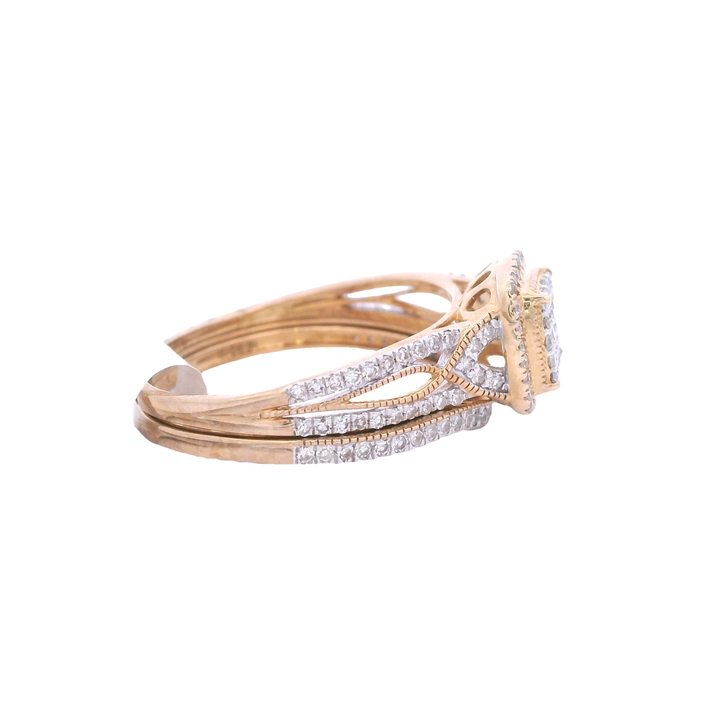 Side view of yellow gold bridal set. The engagement ring is laying on top. It has a square cushion center filled with round diamonds. Outside the center there is a thin gold out line and then a halo made up of round diamonds. The sides have a twist effect between solid gold and the white diamonds. The wedding band is below it and fits perfectly. It has white round diamonds throughout the front of it.