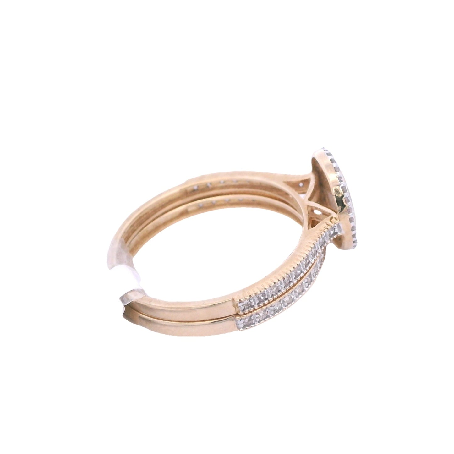 Aerial side view of yellow gold bridal set. The engagement ring center has an oval shape it is filled with round white diamonds. Outside the center there is an outline of thin yellow gold. Then there is a halo of round white diamonds surround the outline. The band has round diamonds on the sides. The wedding ban is laying below it. It has round white diamonds on the front and side of it.