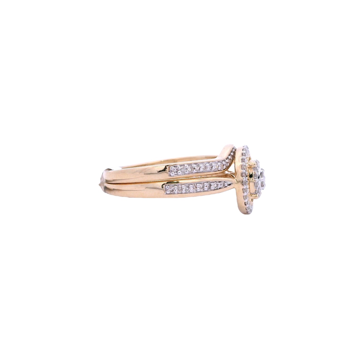 Side view of yellow gold bridal set. The center of the engagement ring is round, it has 2 tiers filled with small round diamonds. Then there is an empty space followed by a thin round gold outline. Outside of the outline there is a halo made up of round diamonds. The bands pinch at the center and expand to fill the sides with round diamonds. The wedding band has round diamonds in the front and sides. It follows the shape of the engagement ring. Here you can see that about 50% of the bands have diamonds