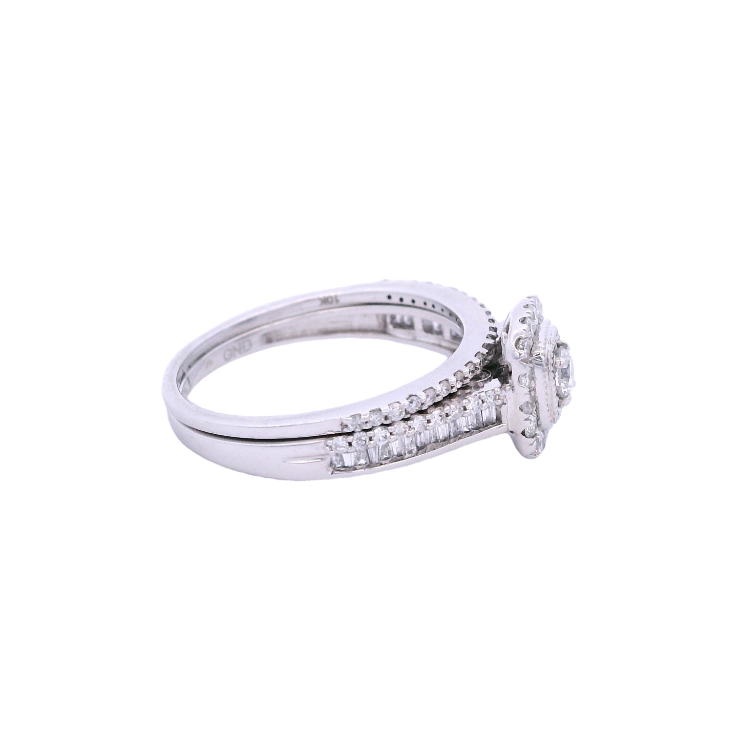 Side view of white gold bridal set. The engagement ring has a round diamond in the center with a rectangular halo that is lined with round pave diamonds. The ring also has a band with a row of round pave diamonds and a row of baguette diamonds. There is a thin wedding band with round pave diamonds on top of the engagement ring.
