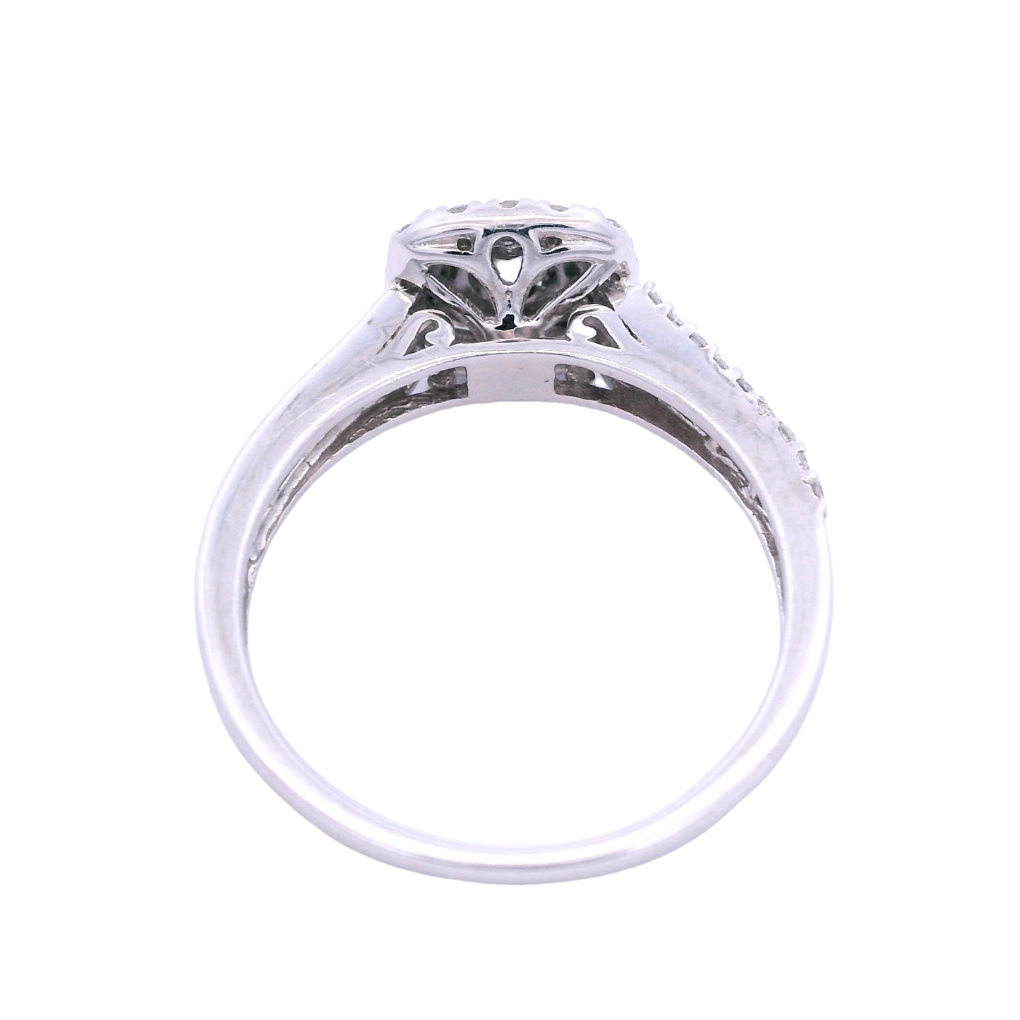 Top view of white gold engagement ring. Here you can see the triangular setting of the diamond. Inside the setting there are elegant swirls and lines.