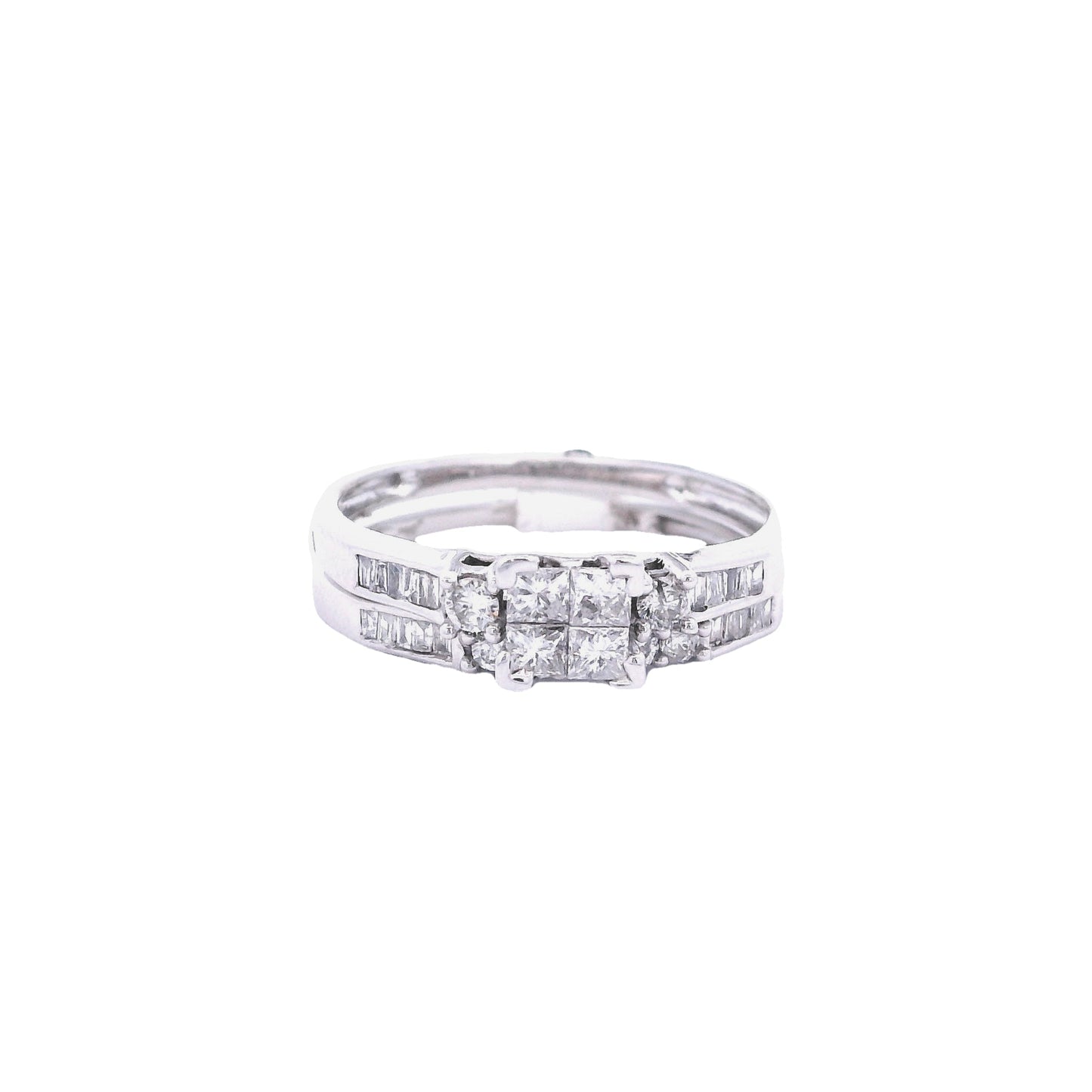 Front of White gold bridal set. The center of the engagement ring is a princess cut made up of 4 square diamonds. On each side of the center of the ring, there is a single round diamond. The band has baguette diamonds towards the center. The wedding band has round diamonds in the center, and baguette diamonds on either side. It is laying under the engagement ring and fits perfectly.