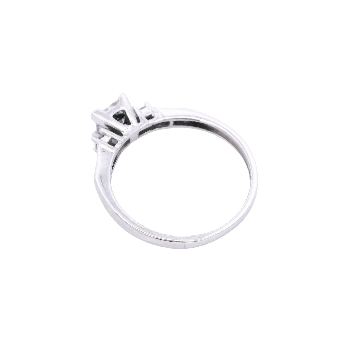 Aerial view of the white gold engagement ring. You can see the triangular shape of the setting of center diamonds.