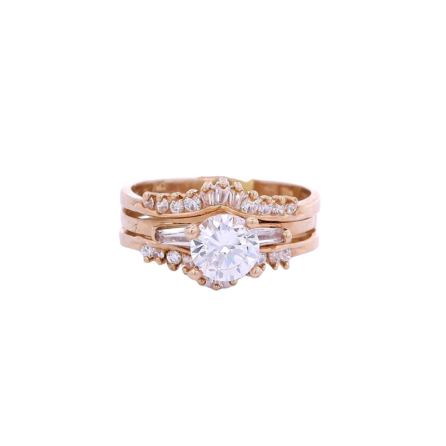 Front view of yellow gold ring with enhancer. The engagement ring has a single white zirconia in the center and 2 white baguette zirconia on each side. The enhancer has graduated baguettes in the center and round white zirconia on the sides.