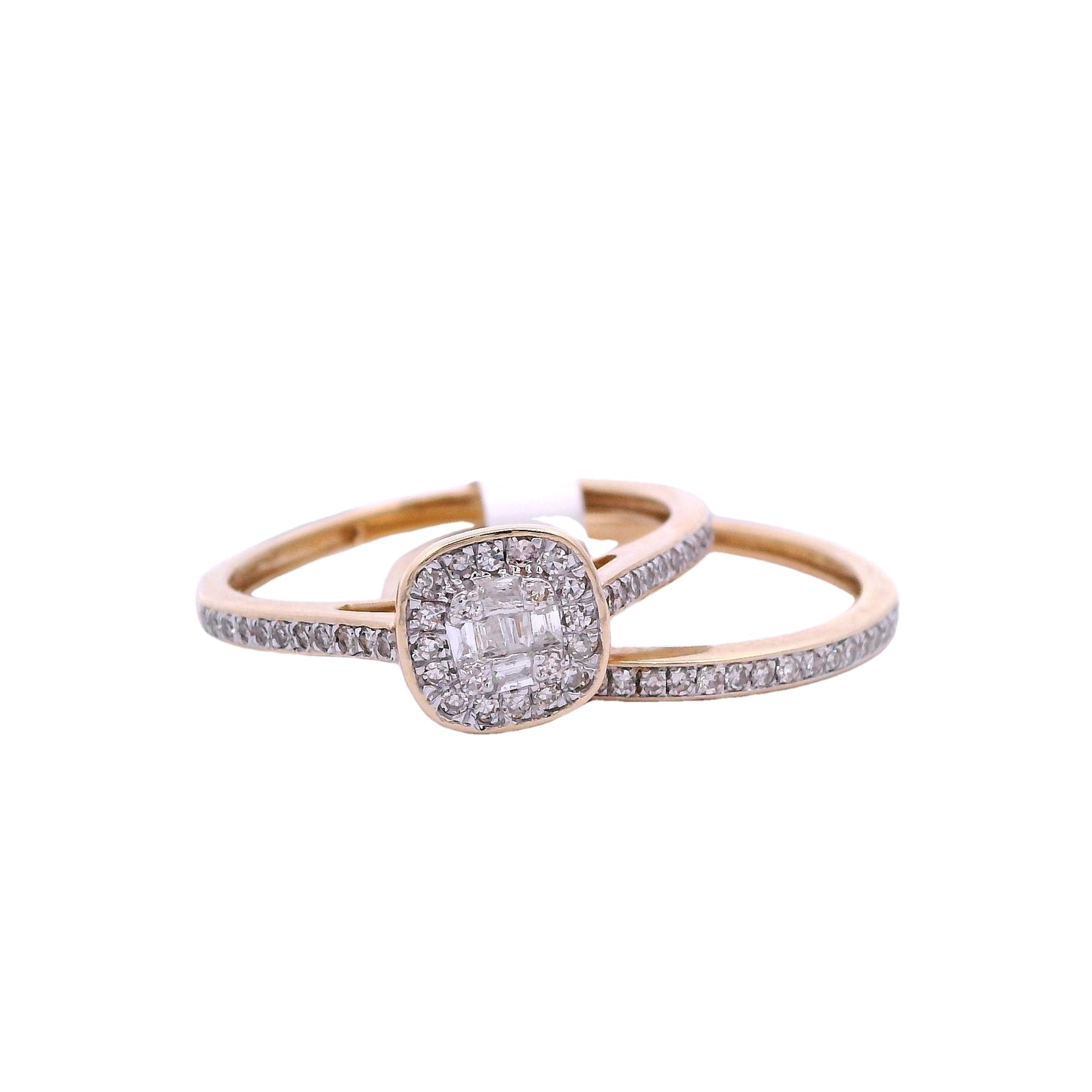Front view of yellow gold bridal set. The engagement ring has a cushion center made up of small square diamonds. It has a halo around it made up of round diamonds, and is outlined in yellow gold. The band of the ring has round diamonds that go about halfway through each side of the band. It is on the left side of the screen at an angle. The wedding band is on right side of the screen. It is a yellow gold thin band with round white diamonds.