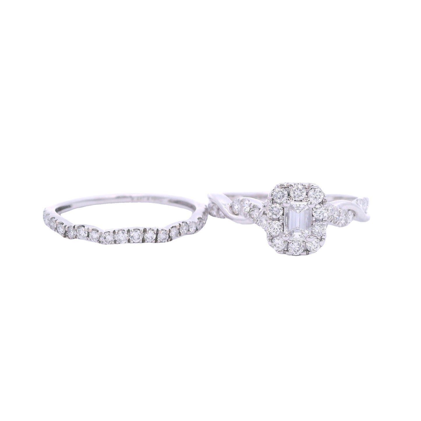 Front view of white gold bridal set. The engagement ring has a baguette diamond in the center and a rectangular halo made up of round zirconia. The engagement ring band has a twist effect with two thin bands: a solid and pave diamond one. The wedding band is next to it on the left of the screen and has pave diamonds. It matches the shape of the engagement ring.