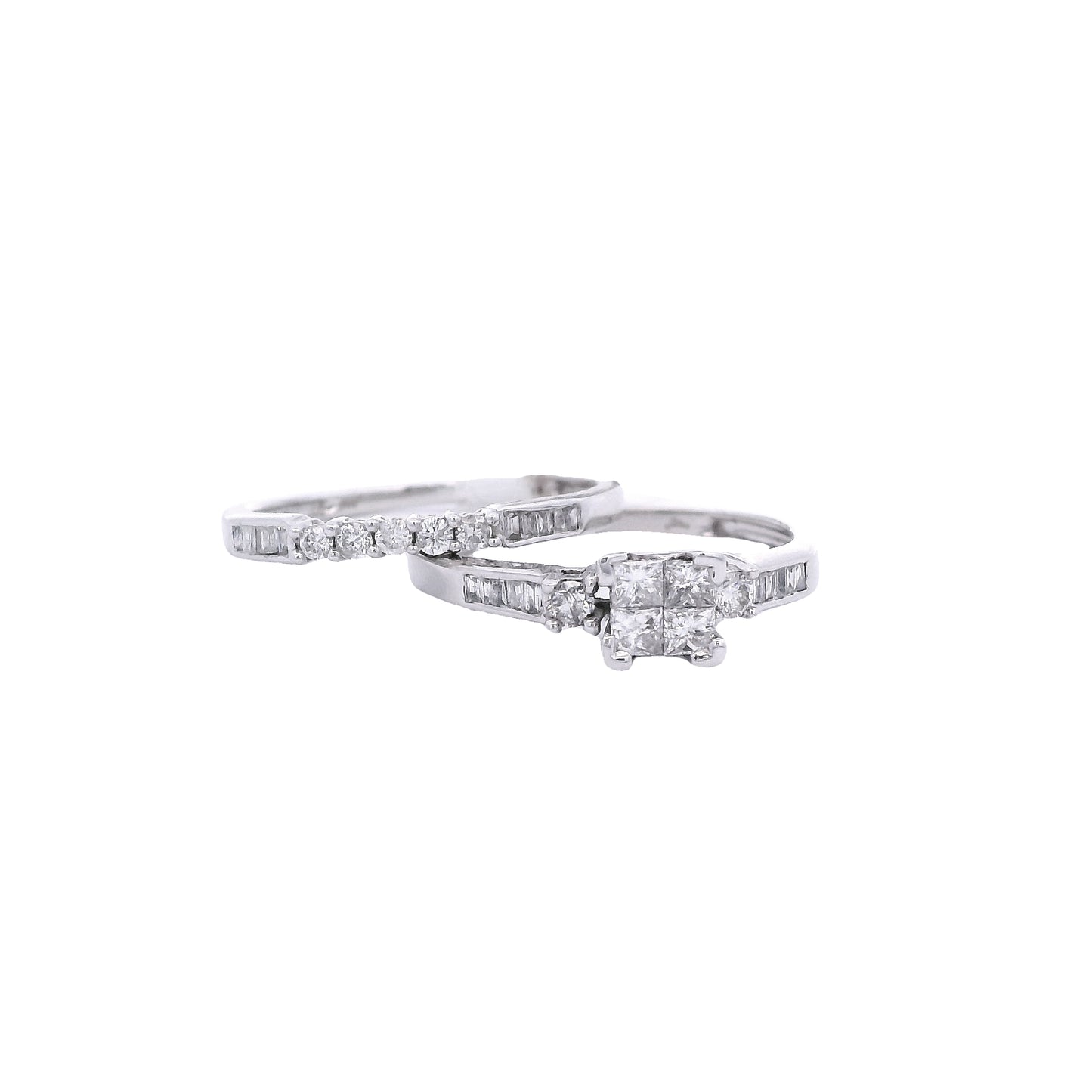 Front view of White gold bridal set. The center of the engagement ring is a princess cut made up of 4 square diamonds. On each side of the center of the ring, there is a single round diamond. The band has baguette diamonds towards the center. The wedding band has round diamonds in the center, and baguette diamonds on either side. It is laying over the engagement ring at an angle on the left of the screen.