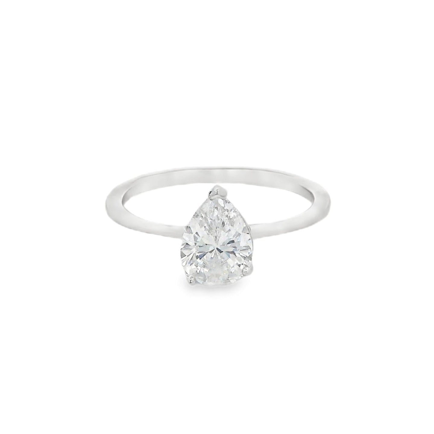 Front view of silver engagement ring that has a thin solid band and a clear teardrop shaped zirconia in the center.