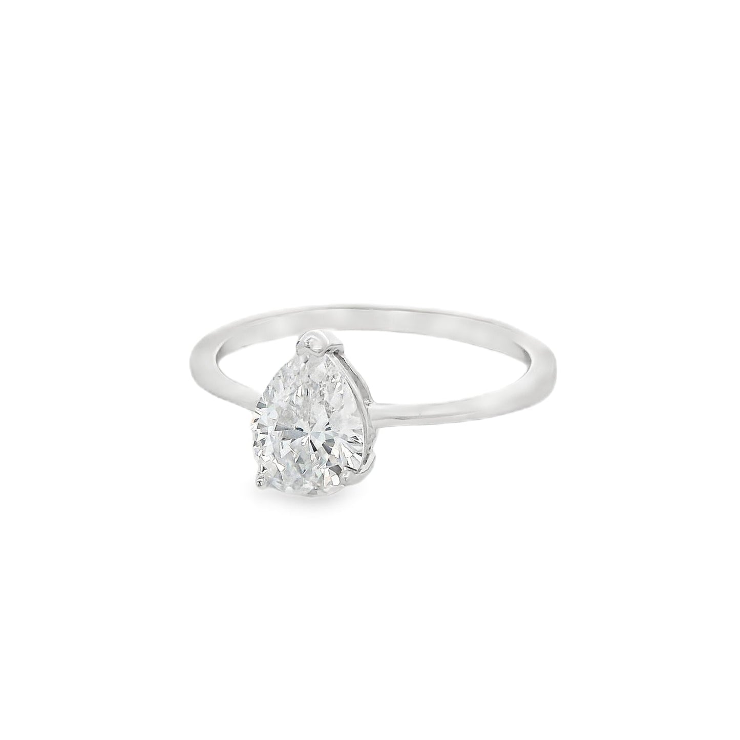 Side angle view of silver engagement ring that has a thin solid band and a clear teardrop shaped zirconia in the center.