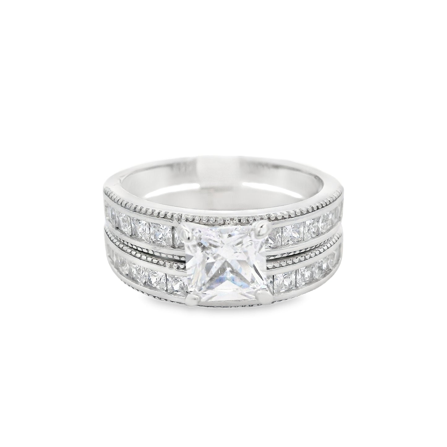 Front view of two of the rings: the engagement ring and smaller wedding band. The wedding band is on the bottom; it has small square zirconia. The engagement ring is on top. It has a large square zirconia in the center and smaller square zirconia on each side.