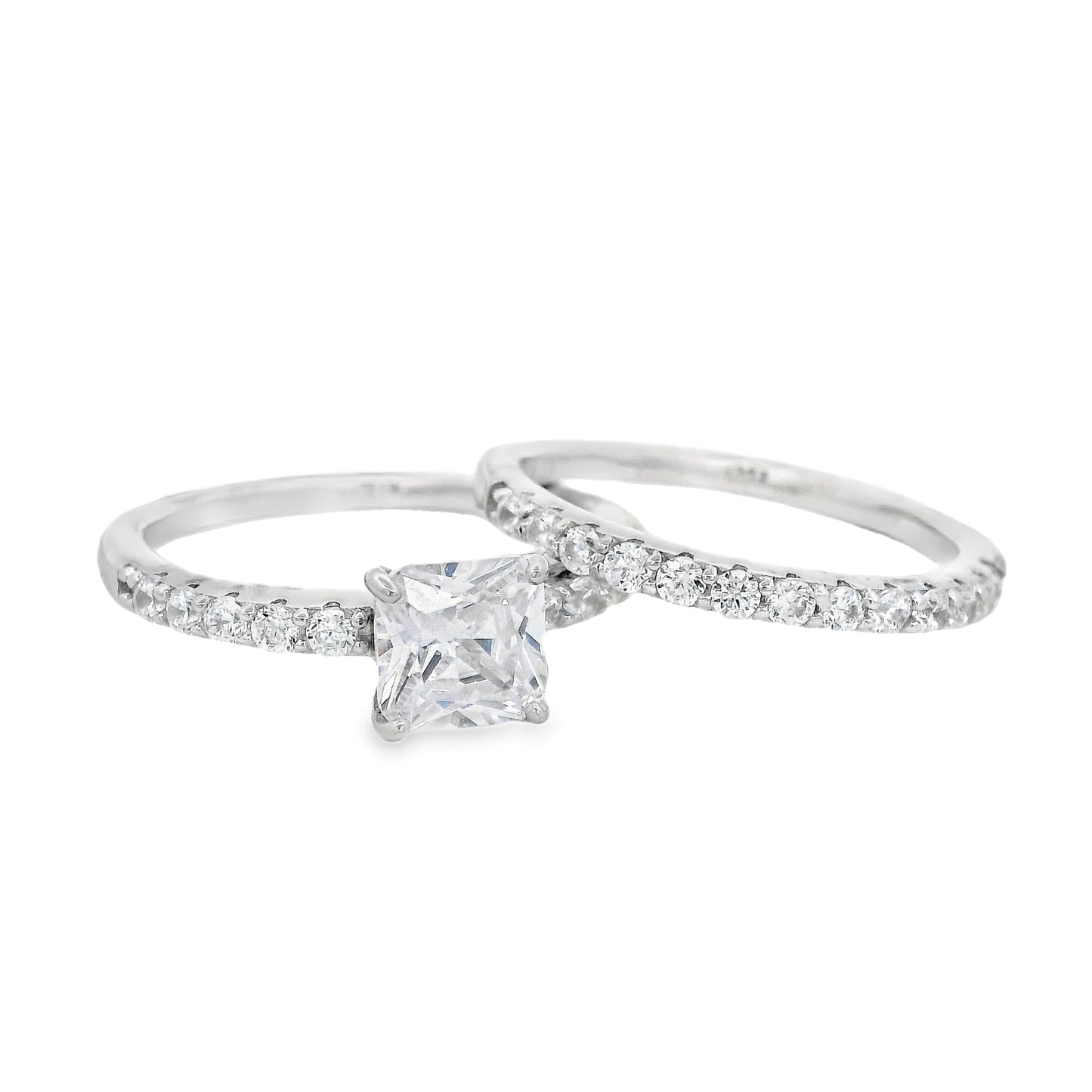 Front view of Silver bridal set. The wedding band is on the right and it has round zirconia in a pave setting. The engagement ring is on the left and it has a single square zirconia in the center and round zirconia on each side in pave setting.