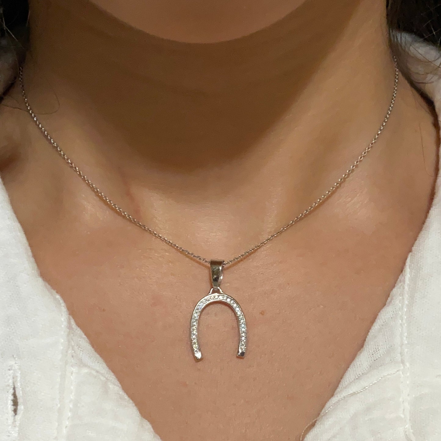 Silver Horseshoe Pendant with Zirconia on silver necklace on model