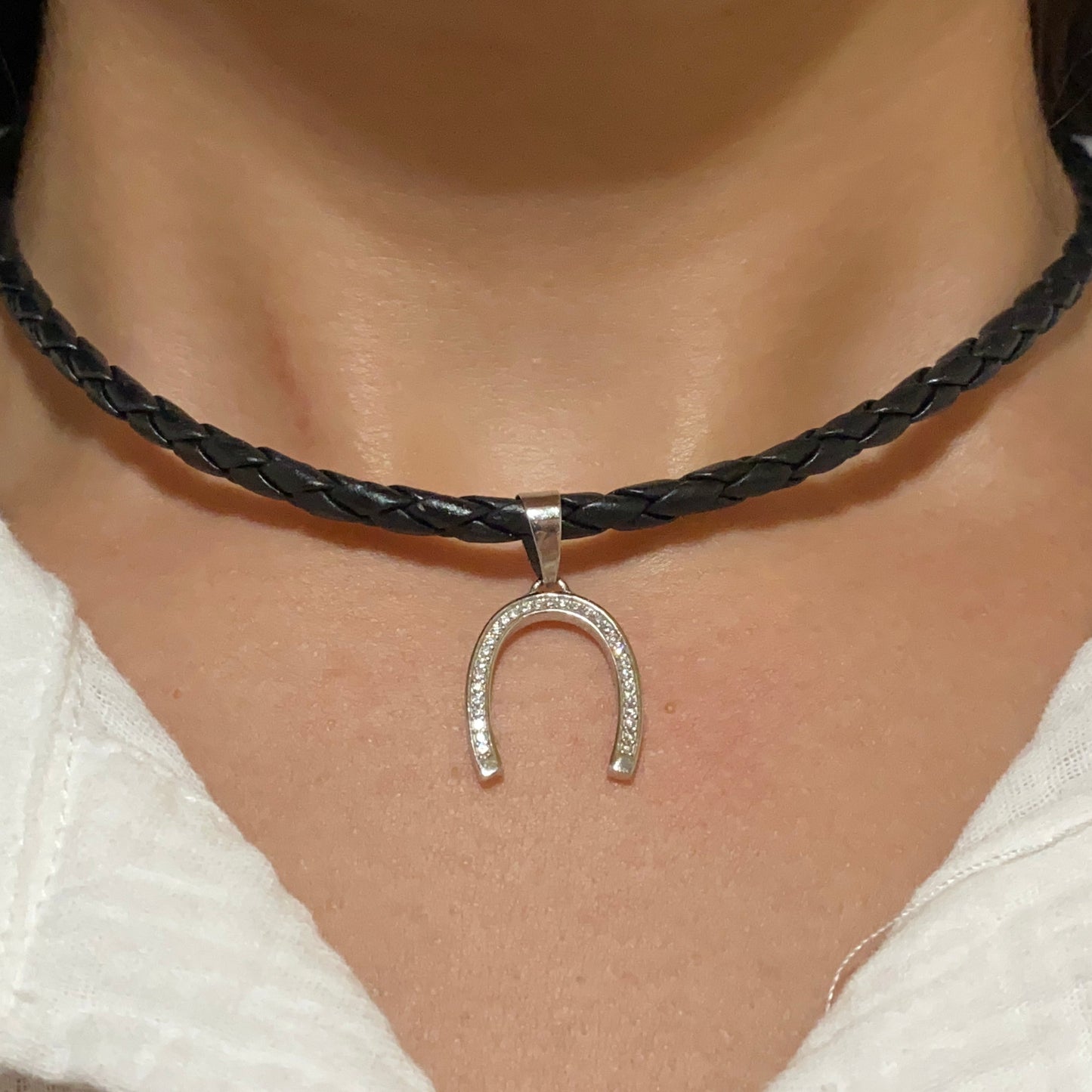 Silver Horseshoe Pendant with Zirconia on leather necklace on model
