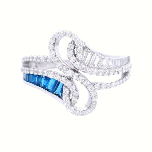 Front view of sterling silver ring with infinity in the center lined with clear pave zirconia. Each side has baguette zirconia one side is clear and the other is royal blue.