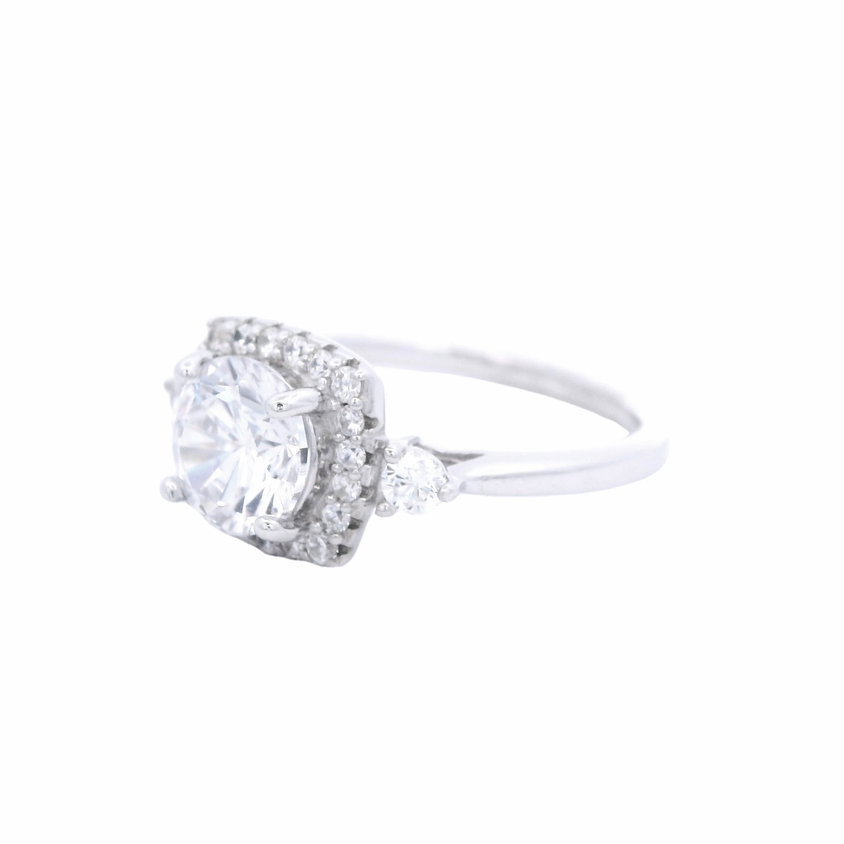 Side view of Sterling silver ring with round white zirconia and a rectangular halo with round white zirconia around it. There is a round white zirconia on each side of the band.