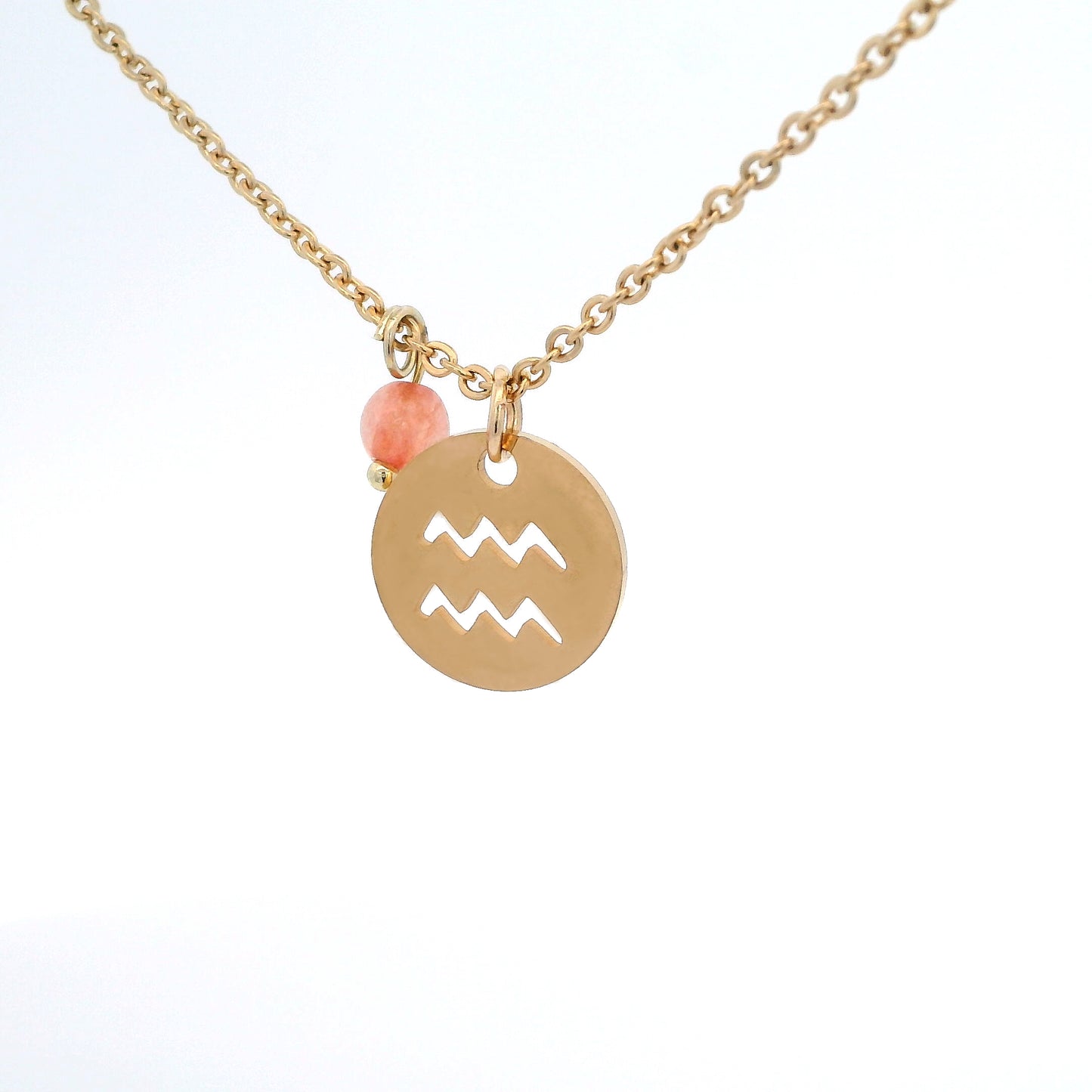 A gold-plated stainless steel chain necklace with a round gold disc pendant featuring a cutout symbol of the Aquarius zodiac sign, adorned with a small bead, on a white background.