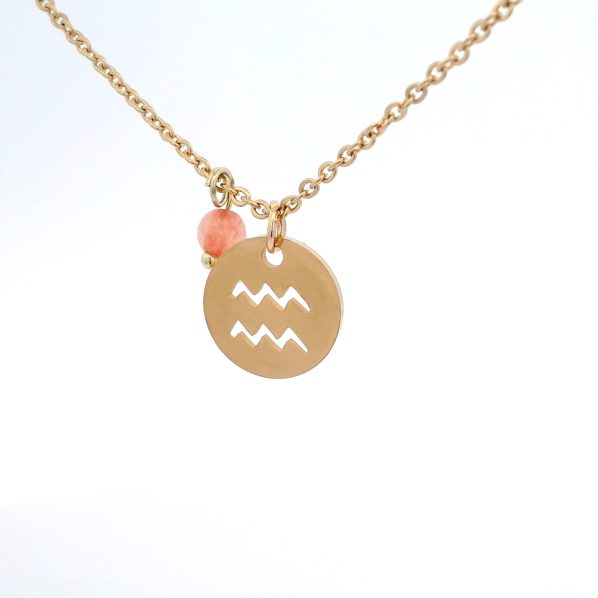 A gold-plated stainless steel chain necklace with a round gold disc pendant featuring a cutout symbol of the Aquarius zodiac sign, adorned with a small bead, on a white background.