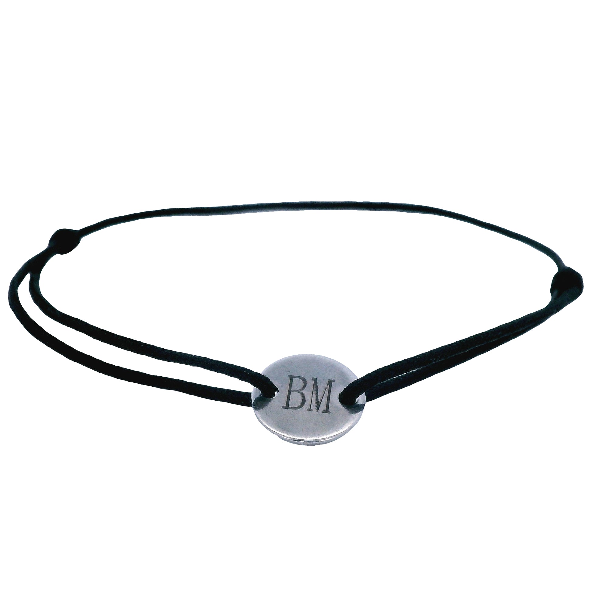 Black string bracelet with a round  stainless steel featuring the initials "B" and "M" in the middle on a white background