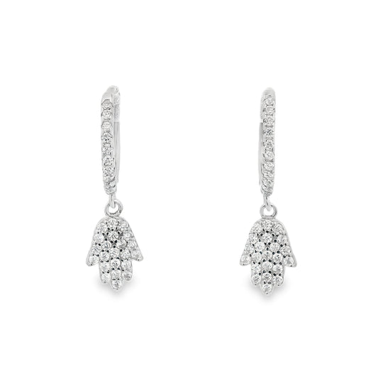 Front view of silver hoops with round clear zirconia and a hamsa hand that dangles below each huggie that also has round zirconia inside it.