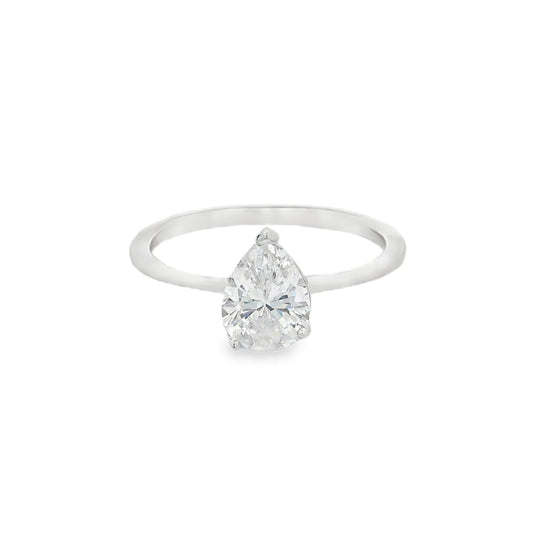 Front view of silver engagement ring that has a thin solid band and a clear teardrop shaped zirconia in the center.