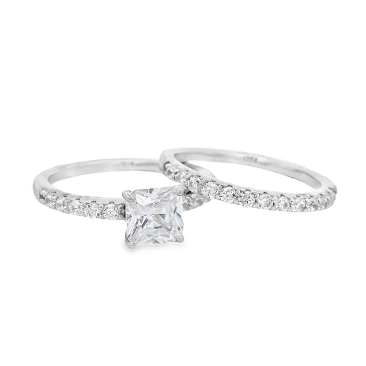 Front view of Silver bridal set. The wedding band is on the right and it has round zirconia in a pave setting. The engagement ring is on the left and it has a single square zirconia in the center and round zirconia on each side in pave setting.