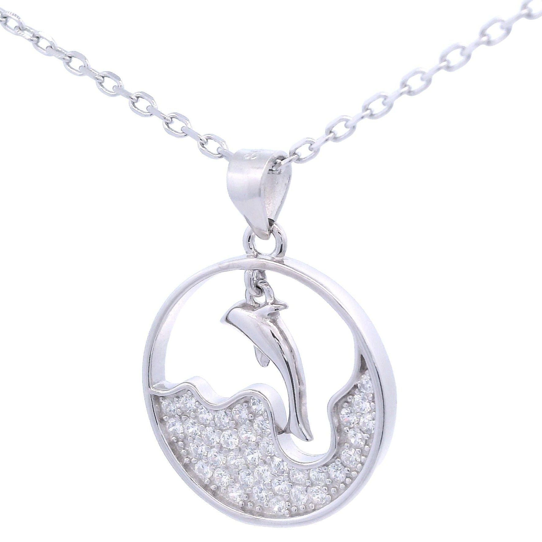 Silver necklace with round pendant that had a wave design with zirconia and a dangling dolphin in the center. Side view.